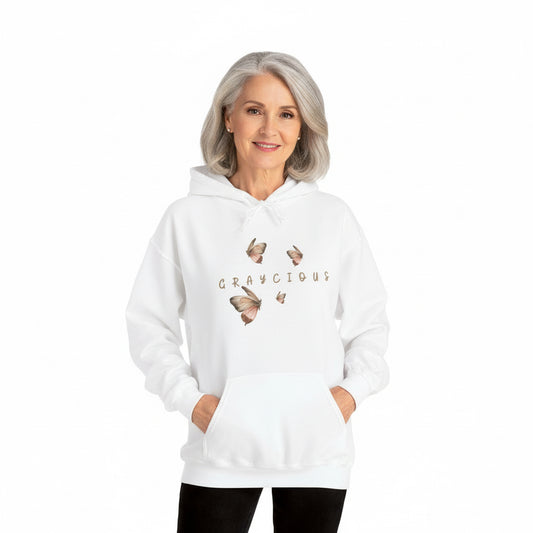 Person wearing a white hoodie with butterfly designs and text on a white background