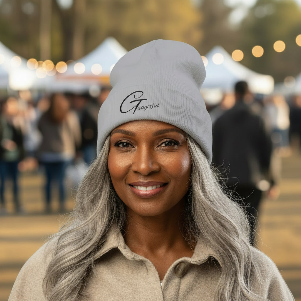 Woman wearing a gray beanie with a logo at an outdoor event