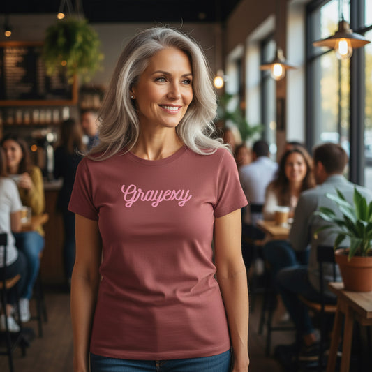 Woman wearing a maroon t-shirt with 'Grayexy' text in a casual setting